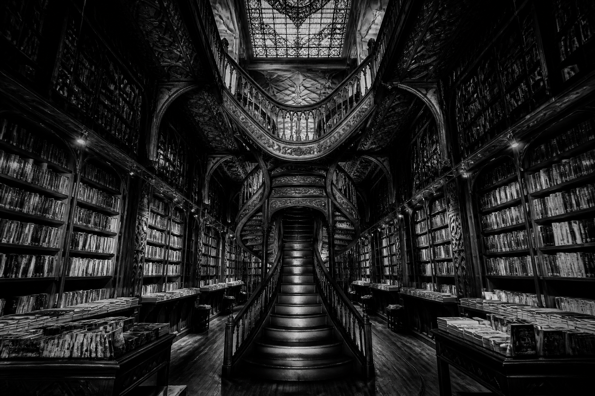Black-and-white neo-gothic library interior with a carved wooden staircase